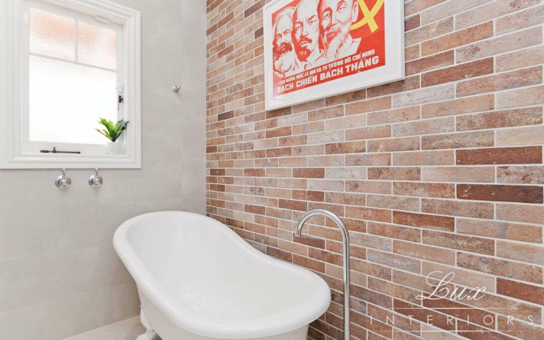 freestanding bath and bricked wall